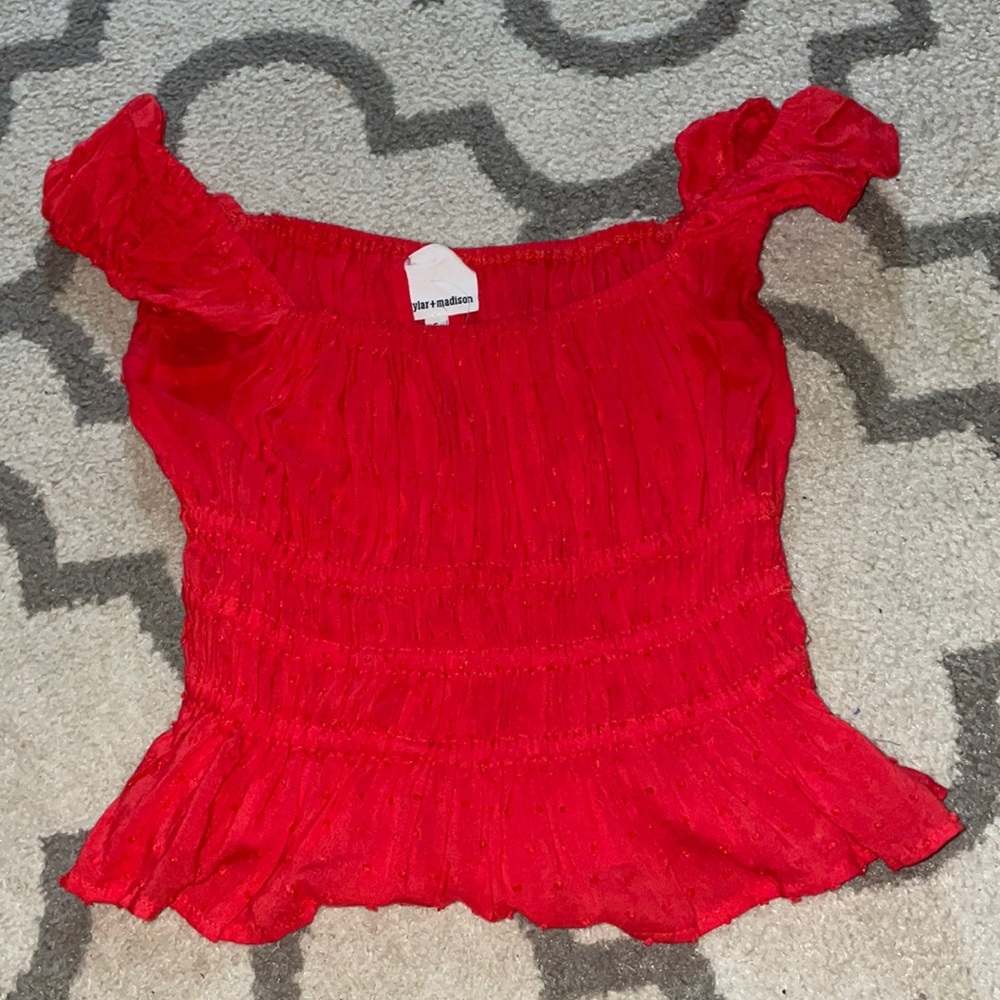 Woman’s red top.